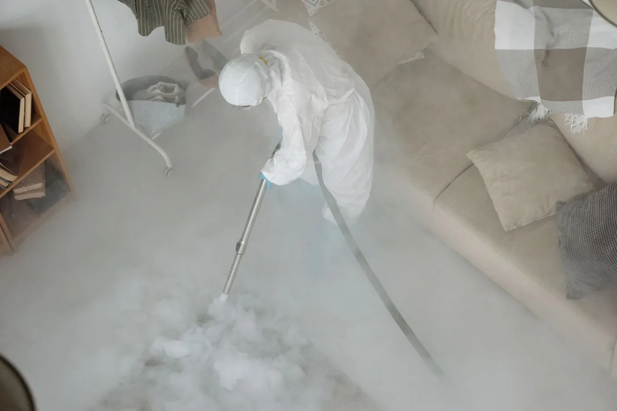 Biohazard cleanup technician in protective equipment, Village of Grosse Pointe Shores, MI